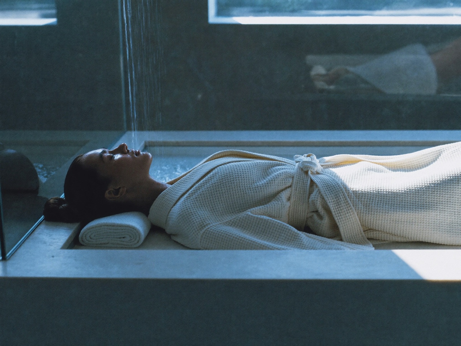 Guest at rest in a serene recovery suite